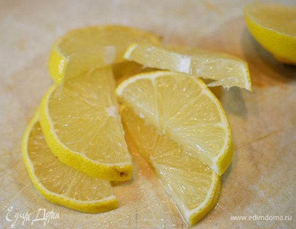 Лимон нарежьте дольками.
