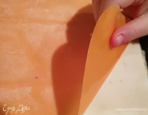 Теперь коврик либо ткань переносим вместе с тестом на противень, переворачиваем, укладываем тесто. Коврик легко отойдет если периодически посыпать мукой. 