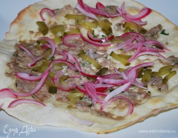 На готовую лепешку положить маринованный лук и маринованный огурец. Свернуть лепешку пополам.