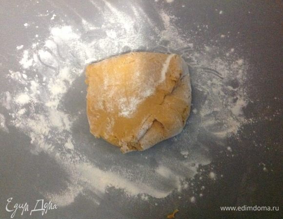 Посыпаем рабочую поверхность стола щепоткой муки, выкладываем прямо в нее первый кусочек тесте и обминаем его еще хорошо в этой муке, чтобы тесто стало менее липкое.