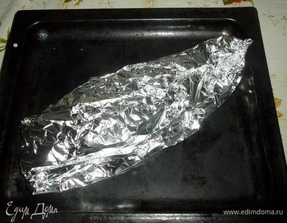 Закрываем рыбу фольгой. Помещаем противень с рыбой в разогретую духовку. Запекаем 1 час при 180°С.