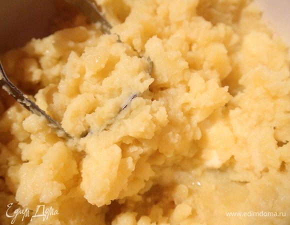 Сварить картофель «в мундире», дать остыть до слегка теплого состояния, очистить, размять, добавив масло, соль, чеснок, пропущенный через пресс, яйца, желток, перемешать.