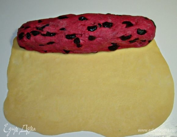 Раскатать белое тесто в прямоугольник (длиной, равной длине формы, в которой будет выпекаться хлеб). С одного края уложить свекольное тесто, раскатанное в «колбаску». Свернуть все рулетом. 