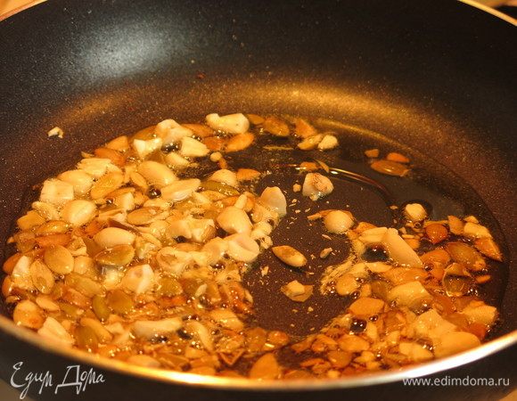 Нарезаем семечки тыквы и слайсы кабачка. Кладем в разогретое оливковое масло семечки.