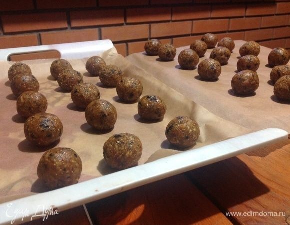 Выкатываем шарики из нашей сладкой массы руками, набирая каждый раз 1 чайную ложку в руку, и выкладываем на доски, застеленные пергаментным листом бумаги, только на этой бумаге конфеты не прилипнут, и их легко можно будет снимать после застывания.