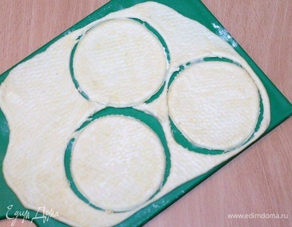 Стаканом, диаметром ~8,5 см, вырезаем четное количество кружочков, у меня получилось 24 шт. Обрезки теста каждый раз смешиваем с новой порцией теста.
    