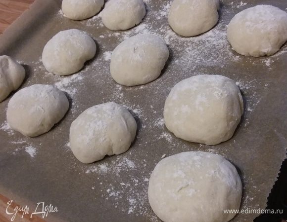 Через 10 минут сформировать булочки и выложить на противень, покрытый пергаментной бумагой. Прикрыть и оставить в теплом месте на 40 минут для расстойки. 