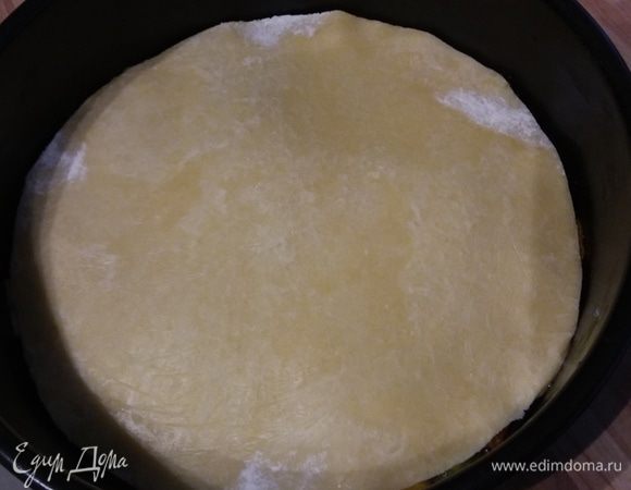 Тесто раскатать чуть больше диаметра формы, выложить на перец и слегка подогнуть края.  