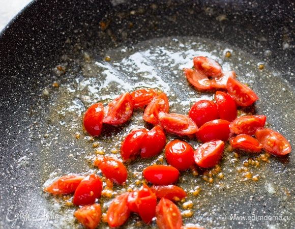 Поставить сковороду на плиту (на средний огонь). Когда сковорода прогреется, растопить на ней кусочек сливочного масла. Добавить помидоры и потушить в течение нескольких минут.
