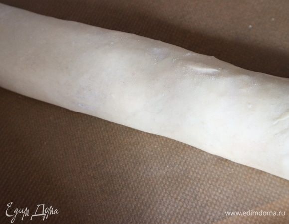 Штрудель выложить на противень, застеленный бумагой для выпечки. Концы рулета подвернуть вниз.