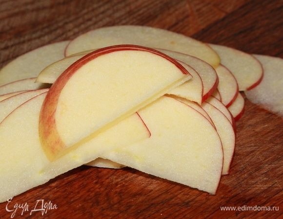 Нарезаем красные яблоки пластинами толщиной 1 мм, топим сливочное масло.