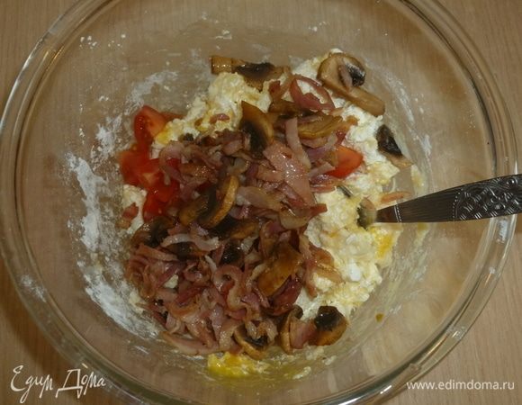 Добавить бекон и грибы, нарезанный помидор. Натереть пармезан. Приправить солью и перцем. Перемешать.