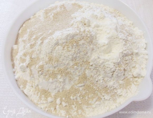 К просеянной муке добавить дрожжи и перемешать.