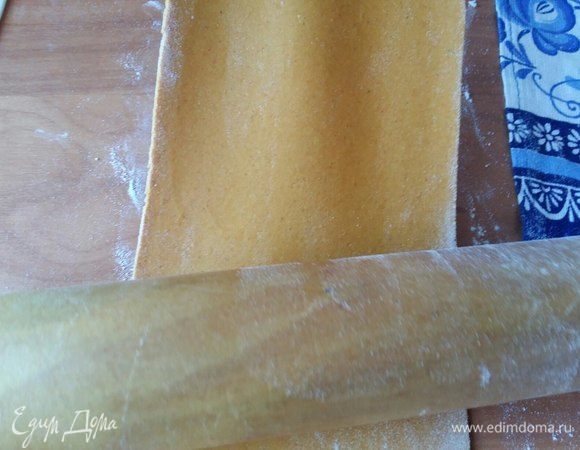 Раскатать часть оранжевого теста. Берем за один край, чуть вытягиваем и скалкой прокатываем. Раскатать в толщину 1,5-1см. Лучше всего, конечно, раскатывать машинкой для раскатки теста, но у меня такой нет.