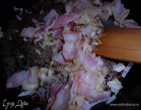 На сковороде подогрейте оливковое масло и обжаривайте лук с панчеттой в течение 5 минут.