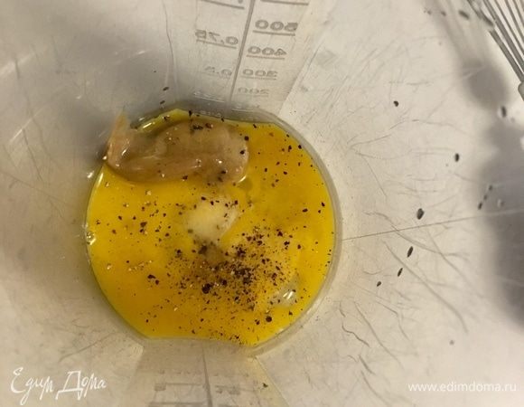 Сначала в емкость к желтку отправляем одну чайную ложку горчицы, немного соли и свежемолотый перец. Начинаем взбивать венчиком.