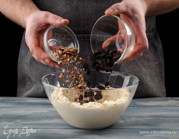 Добавьте в массу изюм и орехи, перемешайте. 