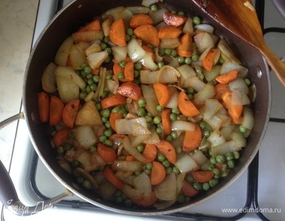 В сотейнике, где жарились ребра, добавить растительное масло и обжарить морковь, лук и зеленый горошек буквально пару минут до золотистости.