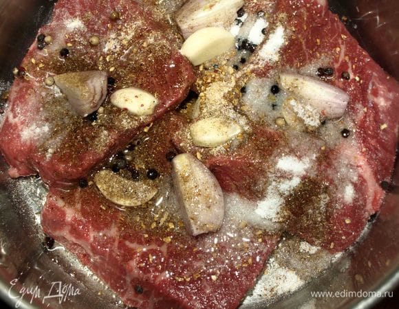 Лук-шалот очистить и нарезать на 4 части. Чеснок очистить и разрезать на две части. В емкость складываем мясо, добавляем кориандр, имбирь, смесь перцев, соль, лук и чеснок.