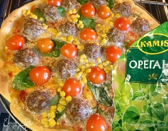 Через 20 мин. заглянуть в духовку. Посыпать пиццу щепоткой орегано.