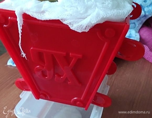 Теперь нужно поставить пасочницу в какую-то миску, для того, чтоб лишняя жидкость могла стекать. А сверху поставить груз. Убрать эту конструкцию в холодильник на 20 часов. С банкой у меня не вошла конструкция, поставила вместо нее 2 тетрапака йогурта. :)