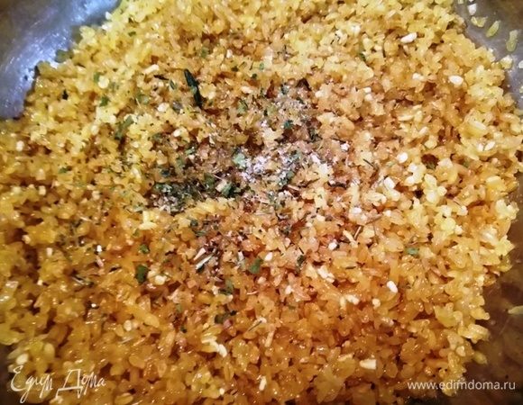 В ароматное кокосовое масло высыпем весь булгур, посолим, поперчим и добавим майоран. Перемешаем и обжарим 5 минут.