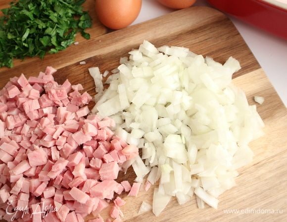 Почистить лук, нарезать лук и ветчину небольшими кубиками. Измельчить зелень петрушки.