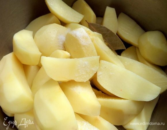 Очистить, нарезать дольками и поставить вариться картофель с солью и лавровым листом.