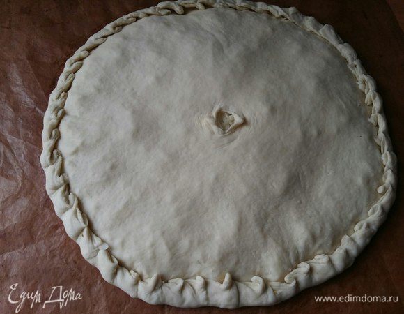 Накрыть второй половиной теста, защипать края пирога, в середине сделать отверстие.
