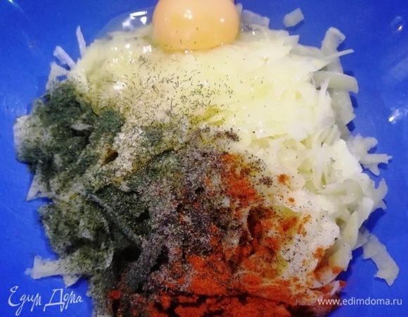 Картофель натираем на средней терке, добавляем специи и яйцо и перемешиваем.