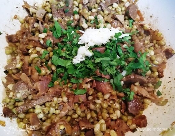 Выкладываем к желудочкам маш, зелень петрушки и чеснок. Перемешиваем. Выключаем огонь.