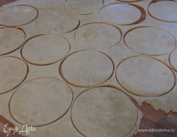На припыленной мукой поверхности раскатать тесто. Оно поначалу довольно тугое, но по мере нагревания становится более податливым. Вырубкой сделать кружки, у меня получилось всего 25 шт.