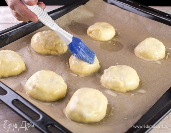 Смажьте пирожки желтком и запекайте в духовке при 180°C 20–25 минут.