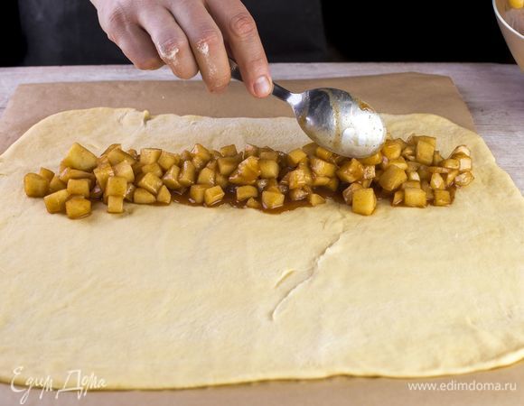 На пергаменте раскатайте тесто и выложите начинку.