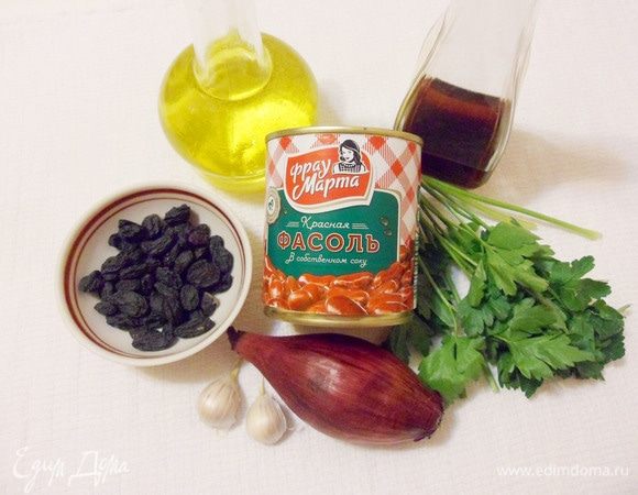 Для приготовления салата нужны: красная консервированная фасоль в собственном соку от ТМ «Фрау Марта», черный изюм без косточек, салатный лук, чеснок, масло оливковое, винный уксус, зелень петрушки, соль и перец.
