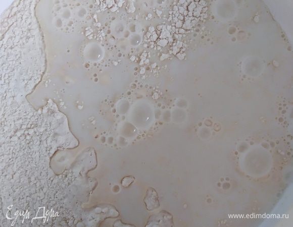 Молоко нагреть, температура — не выше 36°C. Влить молоко к муке, перемешать лопаткой.
