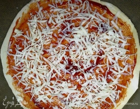 Смазываем основу кетчупом и посыпаем моцареллой.