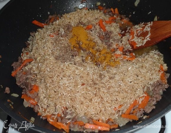 Выложить в сотейник рис, кумин, карри, перемешать.