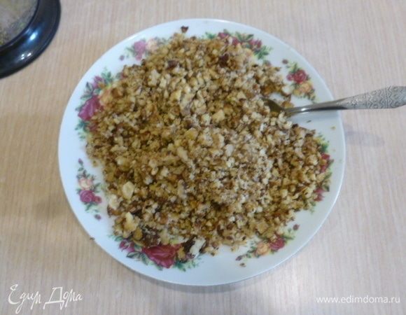 Грецкие орехи перебрать, чтобы в пирог не попали скорлупа и перегородки. Фисташки очистить. Орехи измельчить, немного отложить для украшения. В миске соединить орехи, коричневый сахар, корицу и 50 г обычного сахара. Яйца взбить слегка, добавить к орехам. Также добавить 100 г растопленного масла. Перемешать.