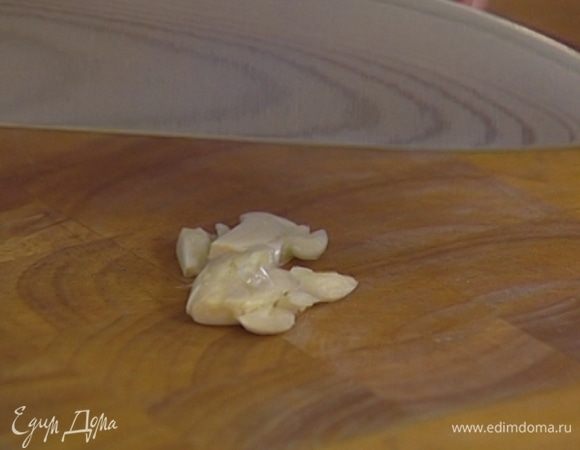 Чеснок почистить и раздавить плоской стороной ножа.
