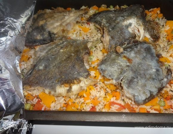 Достать форму из духовки, аккуратно открыть фольгу, выложить камбалу поверх риса с овощами. Снова закрыть фольгой и поставить в духовку еще на 10 минут.