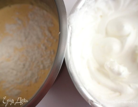 Желтки взбить с 50 г сахарного песка (от общего количества) в пышную светлую массу. Духовку разогреть до 180°C. Добавить к желткам пшеничную муку.