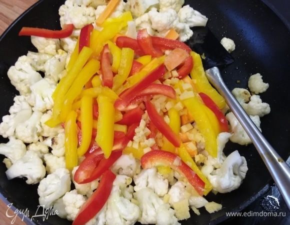 В воке разогреть масло, выложить цветную капусту и обжарить несколько минут. Добавить имбирь, перец и морковь. Обжарить еще несколько минут.