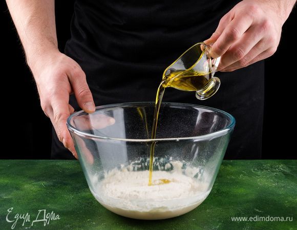 Подогрейте 50 мл кипяченой воды, залейте ею дрожжи, добавьте сахар и 2 ст. л. муки. Все перемешайте и оставьте на 20 минут в теплом месте. Добавьте просеянную муку, остальную воду с растворенной солью, оливковое масло. Замесите тесто. Готовое тесто оставьте на 40 минут на расстойку.