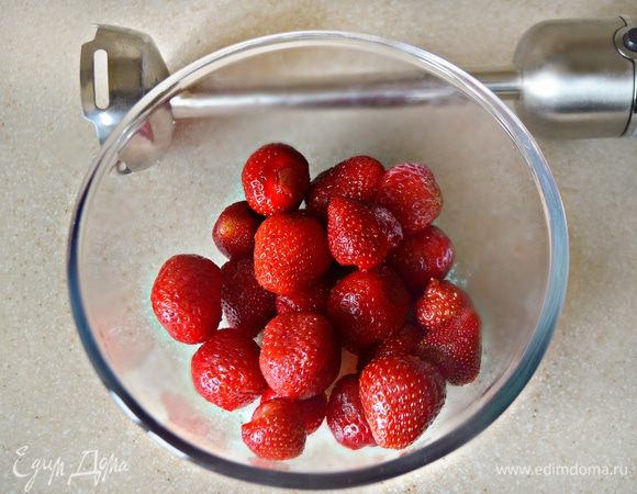 Клубнику вместе с оставшимися 50 г сахара взбить с помощью блендера. 1 пакетик желатина также растворить в кипяченой воде до полного растворения и добавить к клубнике, перемешать.