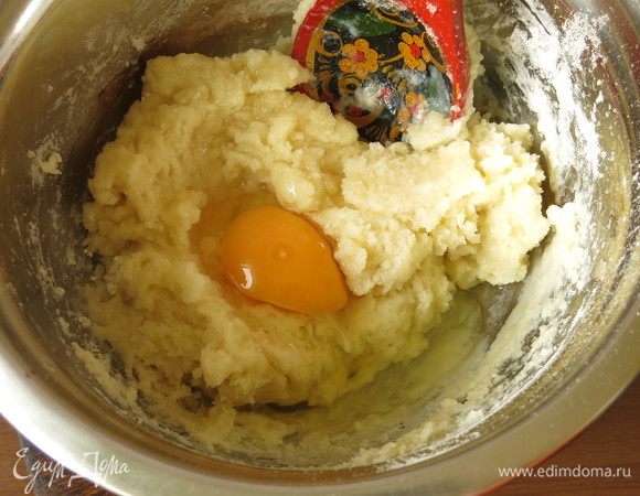 По одному вмешиваем яйца. Вводим сахар. Для несладких вареников сахар не кладем.