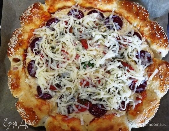 Вынимаем пиццу из духовки, щедро посыпаем моцареллой и ставим обратно на 7 минут.