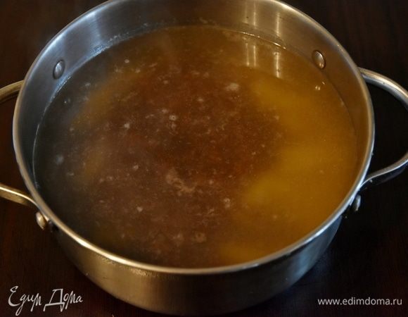 Бульон довести до кипения. Выложить картофель. Через 5–7 минут добавить отварную фасоль. Затем выложить пассерованные овощи с томатной пастой. Огонь уменьшить до минимального и потомить суп еще минут 20–25. Посолить.