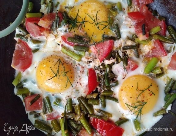 Подавать яичницу горячей, посыпав зеленью укропа.
