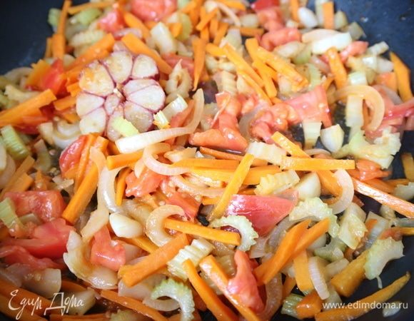 Через 1–2 минуты добавить помидор, слегка обжарить.